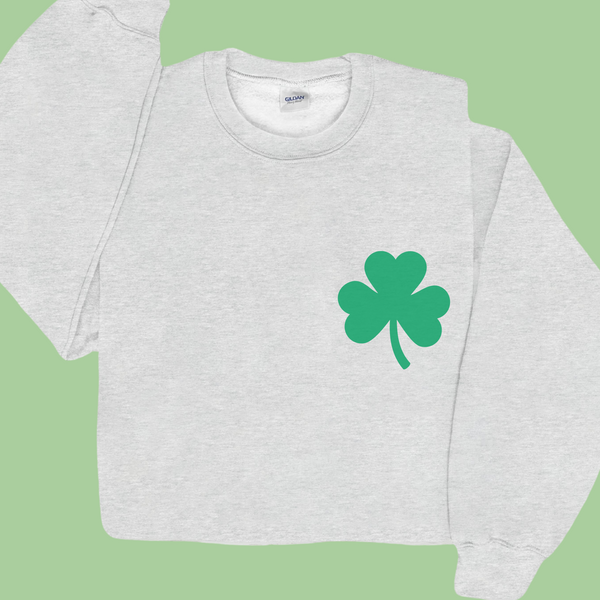 Gray sweatshirt with a green shamrock on a green background