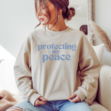 A woman wearing a beige comfy sweatshirt with 