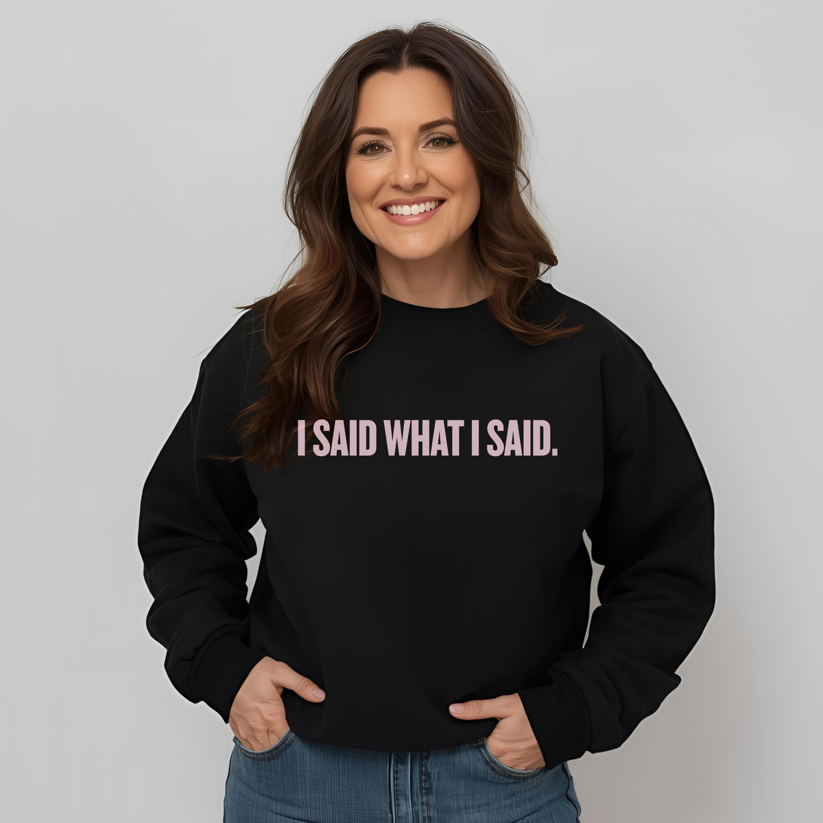 Woman wearing a black sweatshirt with 'I SAID WHAT I SAID.' text on a plain background