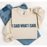 Folded Beige sweatshirt with 'I SAID WHAT I SAID.' text on a white background