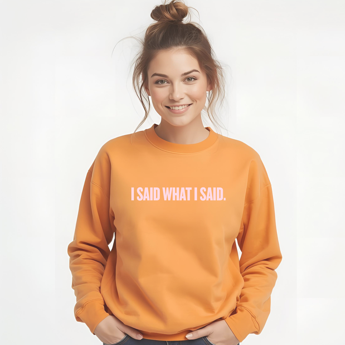 a 30-year old woman wearing an orange sweatshirt with 'I SAID WHAT I SAID.' text on a white background