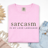 Pink t-shirt with 'sarcasm is my love language' text on a white background