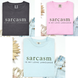 A photo array of the three colors the Sarcasm shirt is available in - black, pink, and blue.