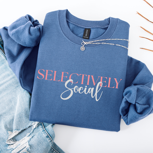 Blue sweatshirt with 'SELECTIVELY Social' text on a white background