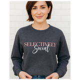 Middle age woman in a dark gray sweatshirt with the words 