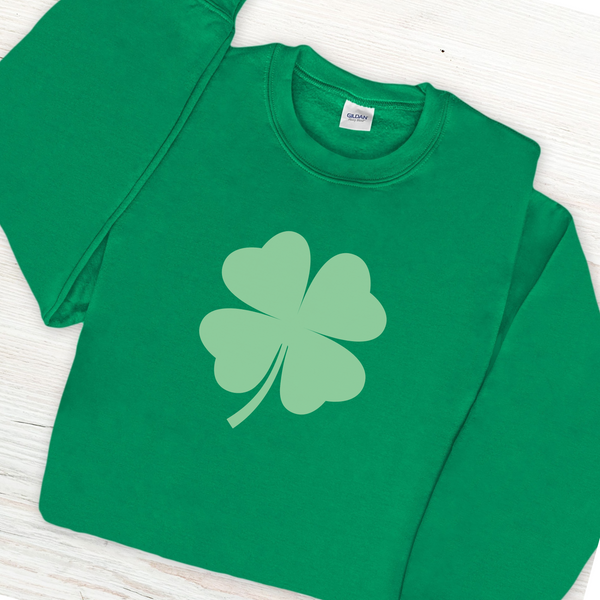 A green sweatshirt with a large lighter green shamrock in the middle.