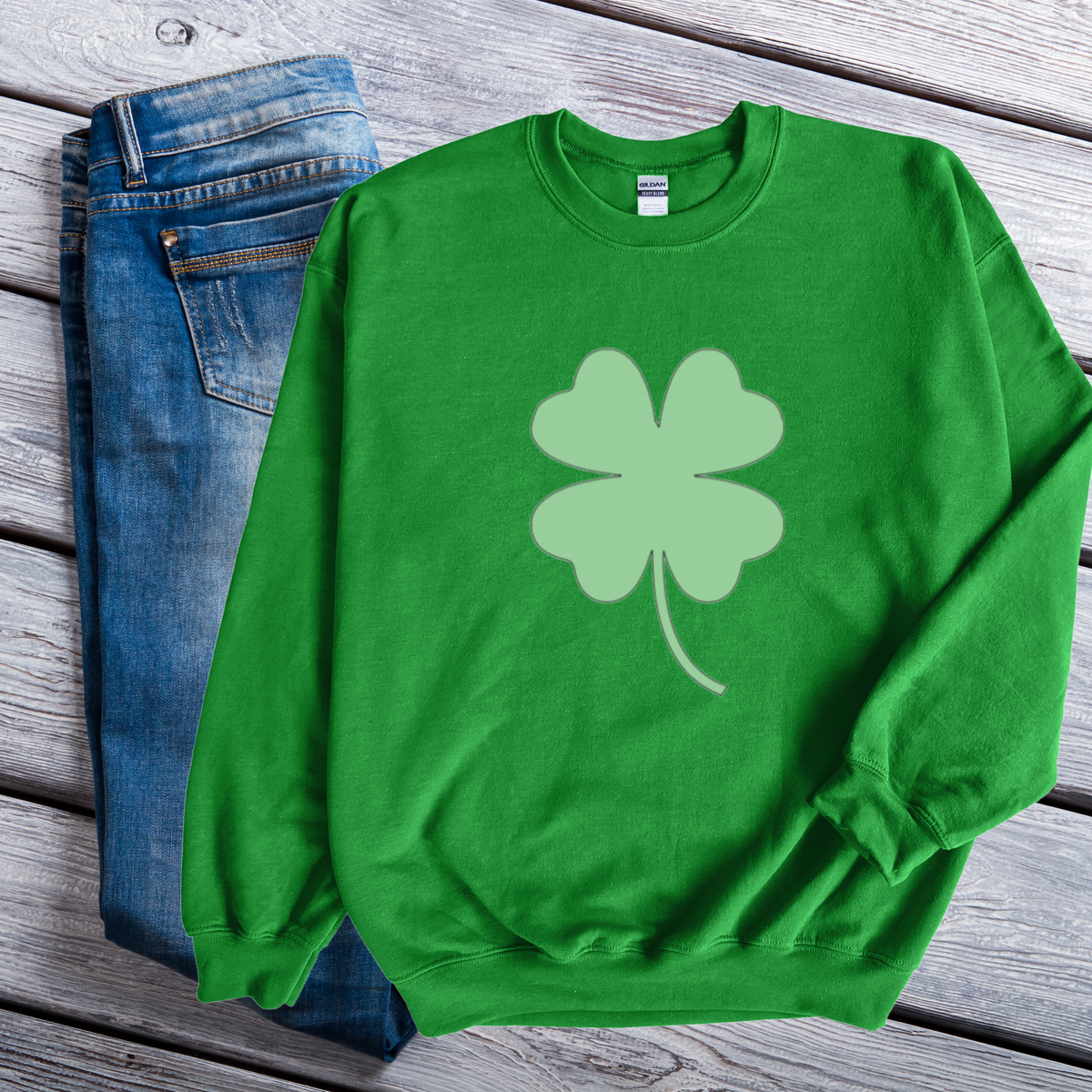A green sweatshirt with a large lighter green shamrock in the middle.