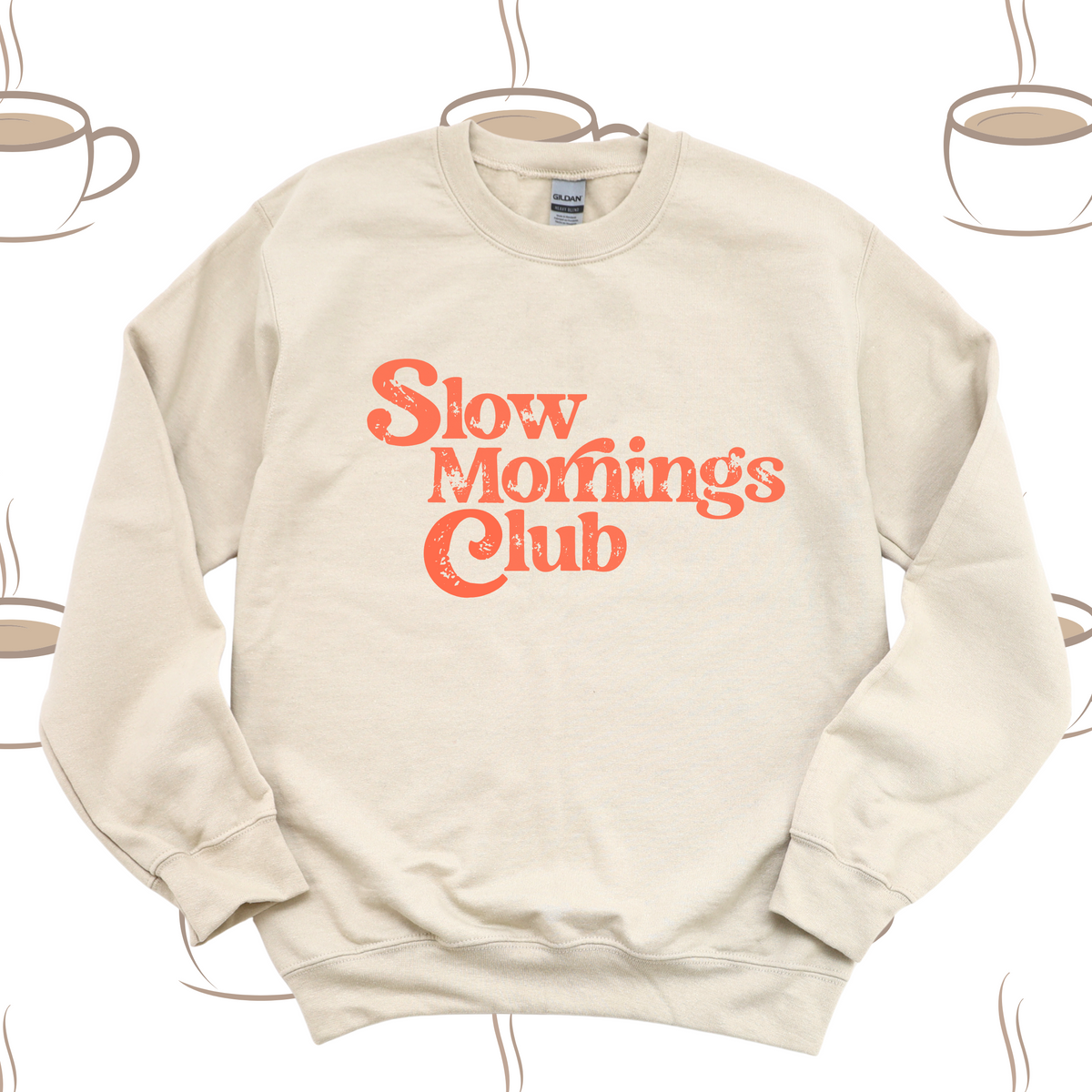 Beige sweatshirt with 'Slow Mornings Club' text on a white background