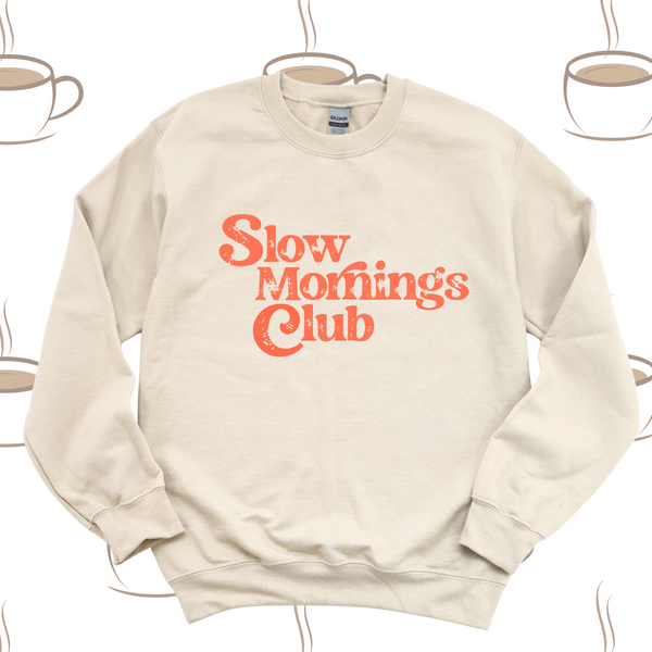 Beige sweatshirt with 'Slow Mornings Club' text on a white background