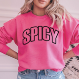 Person wearing a pink sweatshirt with 'SPICY' text, standing against a neutral background.