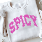 White sweatshirt with pink 'SPICY' text on a light background