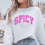 White sweatshirt with pink 'SPICY' text worn by a person, with a neutral background.