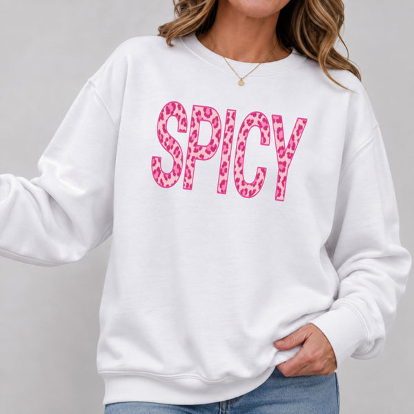 White Spicy leopard print sweatshirt with hot pink lettering, worn with jeans