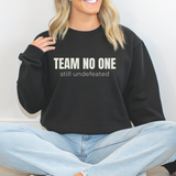 Person wearing a black sweatshirt with 'TEAM NO ONE still undefeated' text, sitting on a white background.