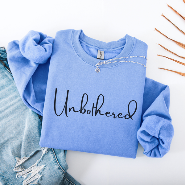 Blue sweatshirt with 'Unbothered' text on a white background