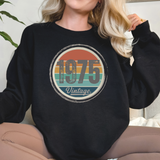 Person wearing a black sweatshirt with '1975 Vintage' design.