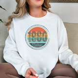 Person wearing a white sweatshirt with '1980 Vintage' design, holding a mug.