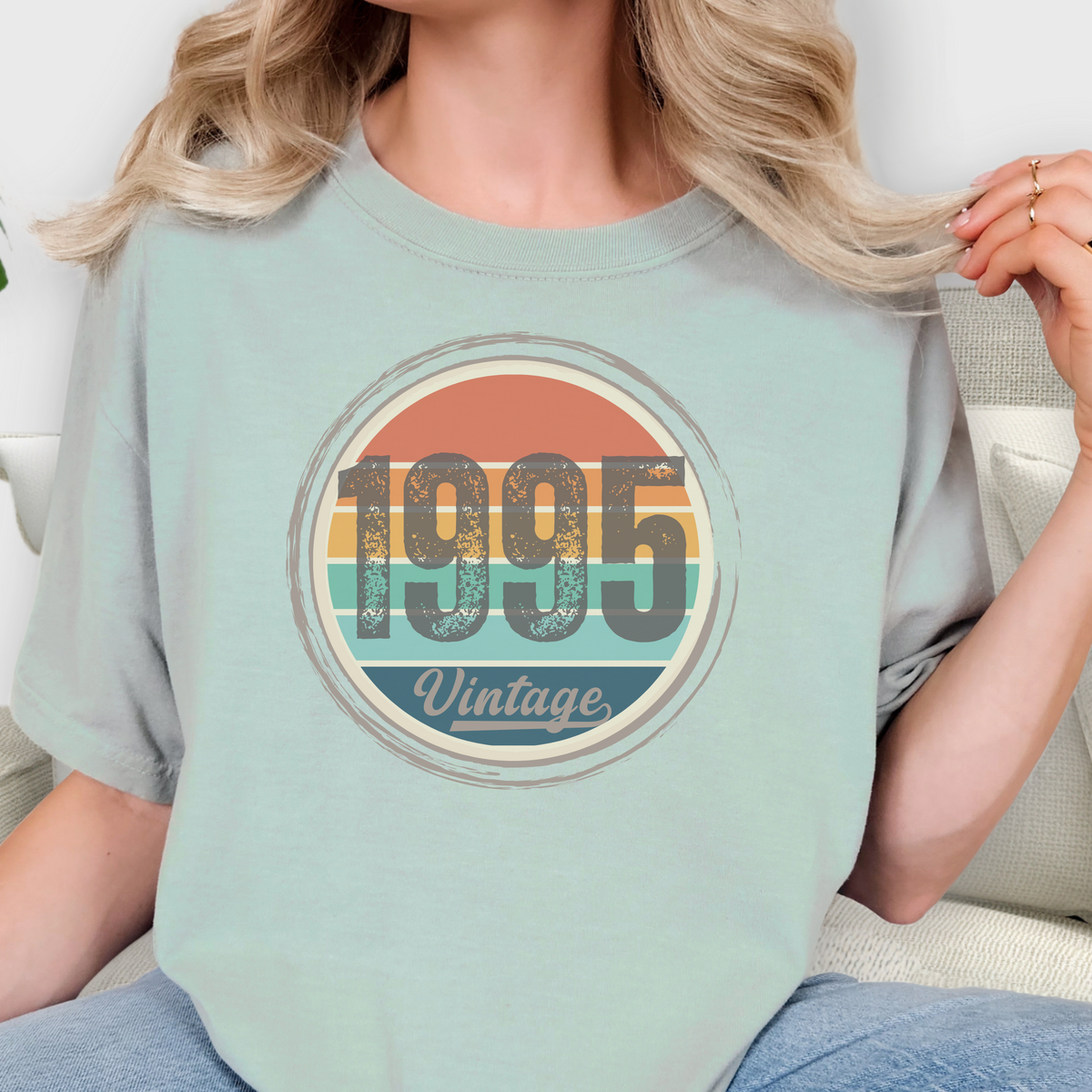 Person wearing a light blue t-shirt with '1995 Vintage' design.