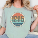 Person wearing a light blue t-shirt with '1995 Vintage' design.