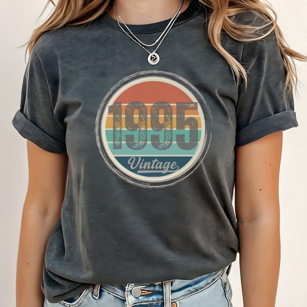 Person wearing a dark gray t-shirt with '1995 Vintage' graphic design.