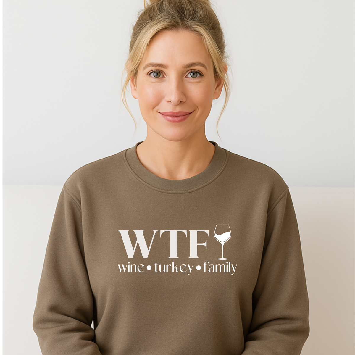 Woman wearing a brown sweatshirt with 'WTF wine turkey family' text