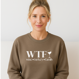 Woman wearing a brown sweatshirt with 'WTF wine turkey family' text