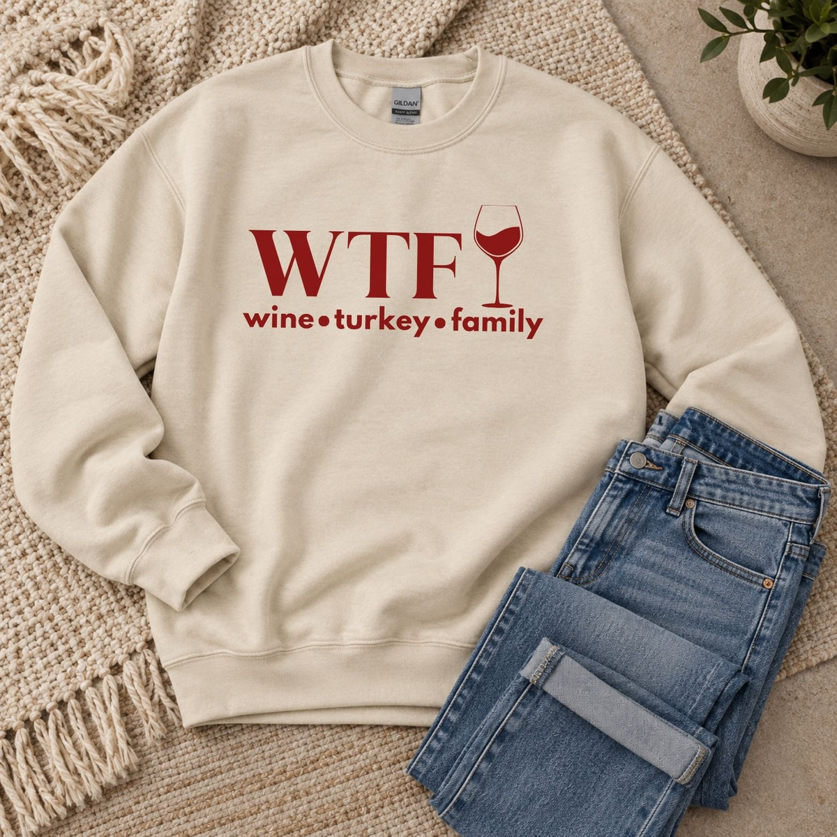 A beige sweatshirt that reads "WTF Wine Turkey Family" and an outline of a wine glass