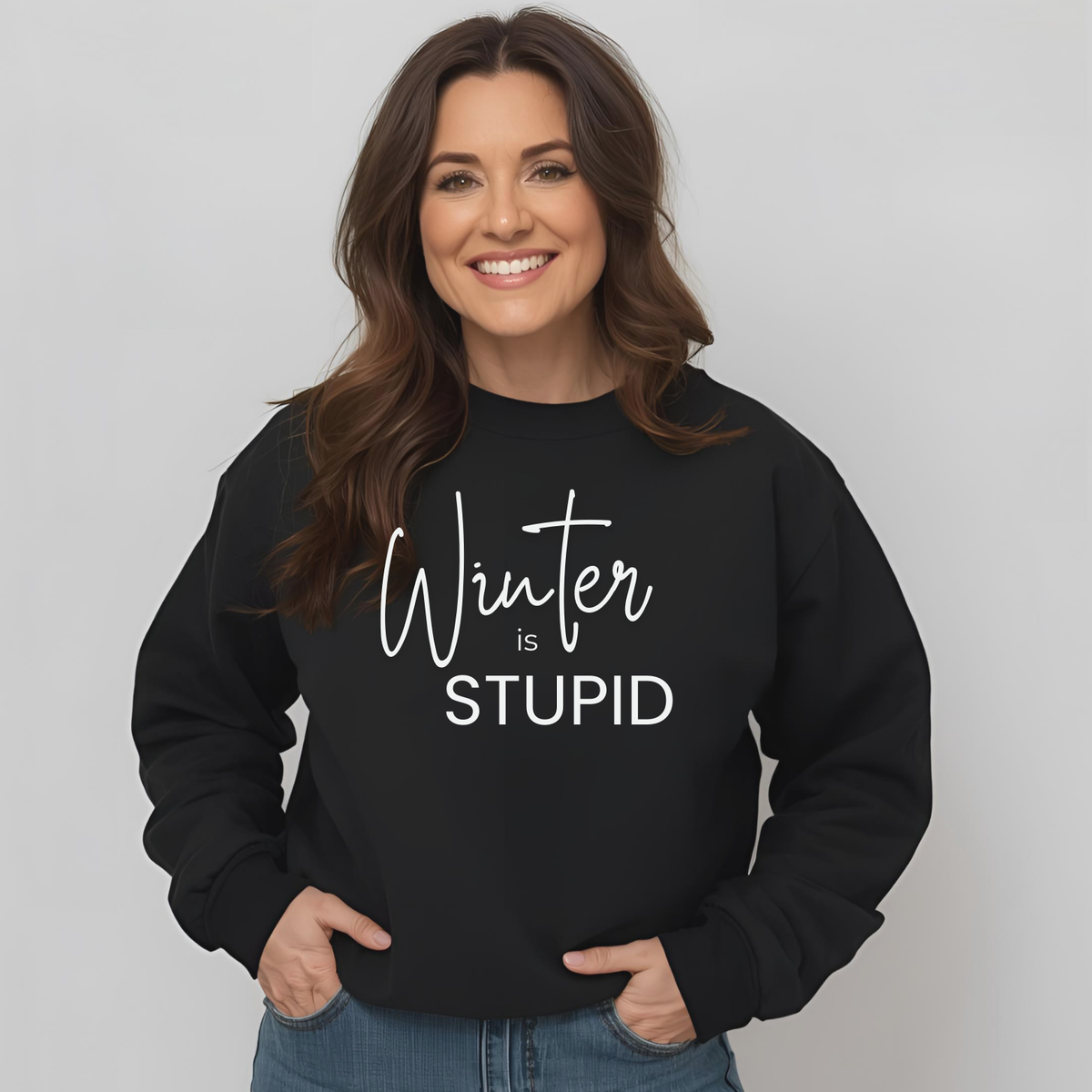 A 40-50 year old Woman wearing a black sweatshirt with 'Winter is STUPID' text on a plain background