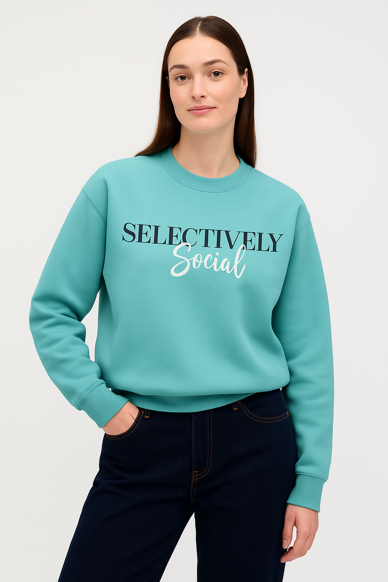Person wearing a teal sweater with 'SELECTIVELY Social' text on a white background
