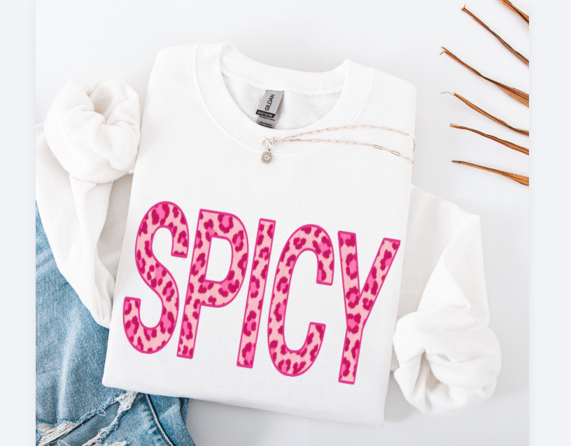 White sweatshirt with 'SPICY' in pink leopard print on a white background