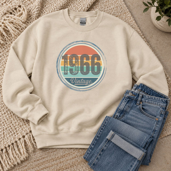 Sand vintage birthday sweatshirt laid flat, showing the retro sunset birth year design.